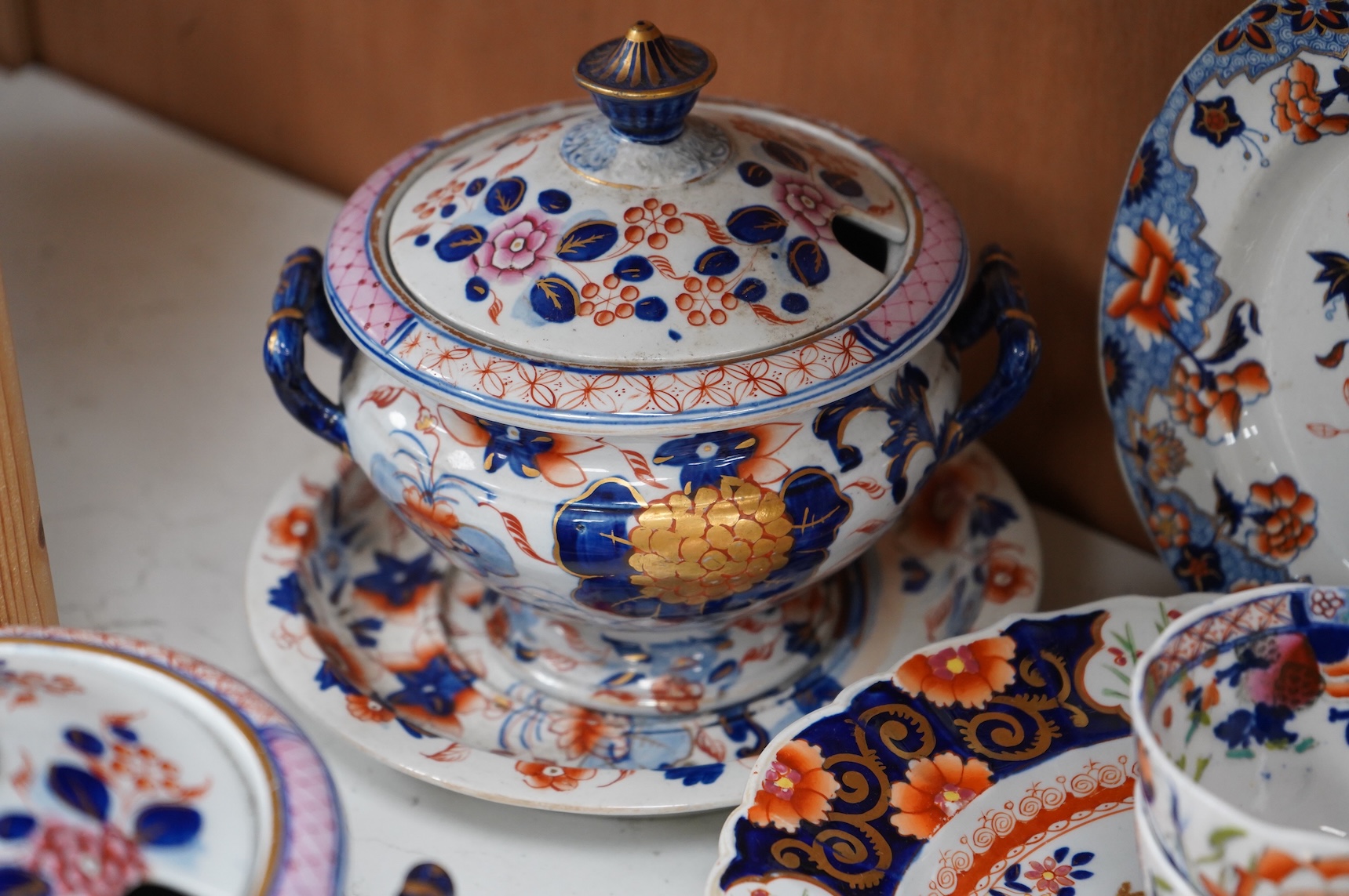 A collection of 19th century English ironstone china to include two pairs of sauce tureens, covers and stands, one marked Masons, various side plates and teacups